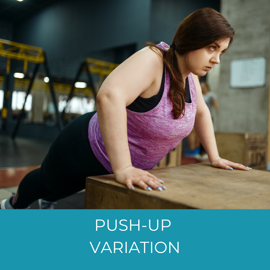 woman doing a push-up variation on a box in a gym
