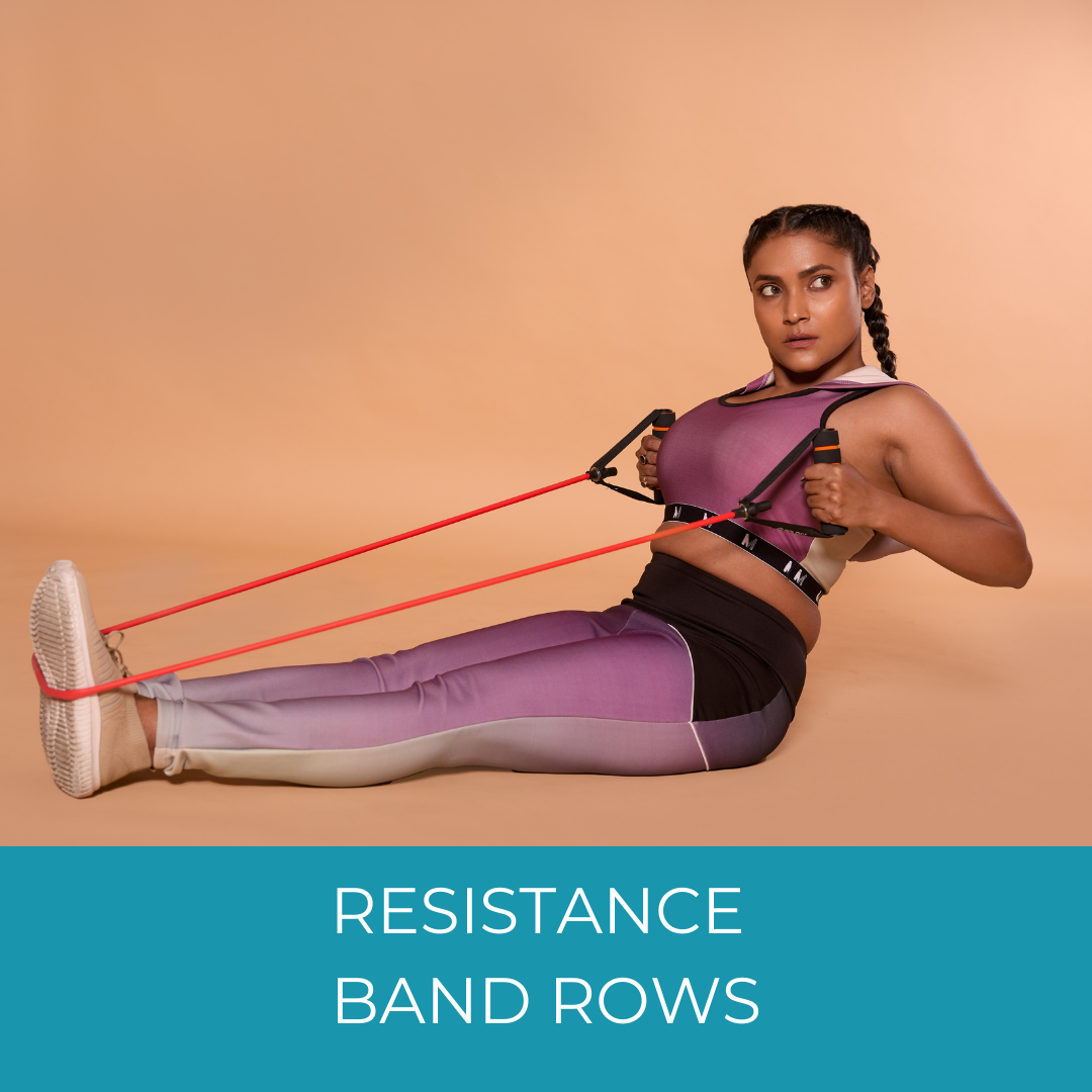 woman doing rows with a resistance band wrapped around her feet