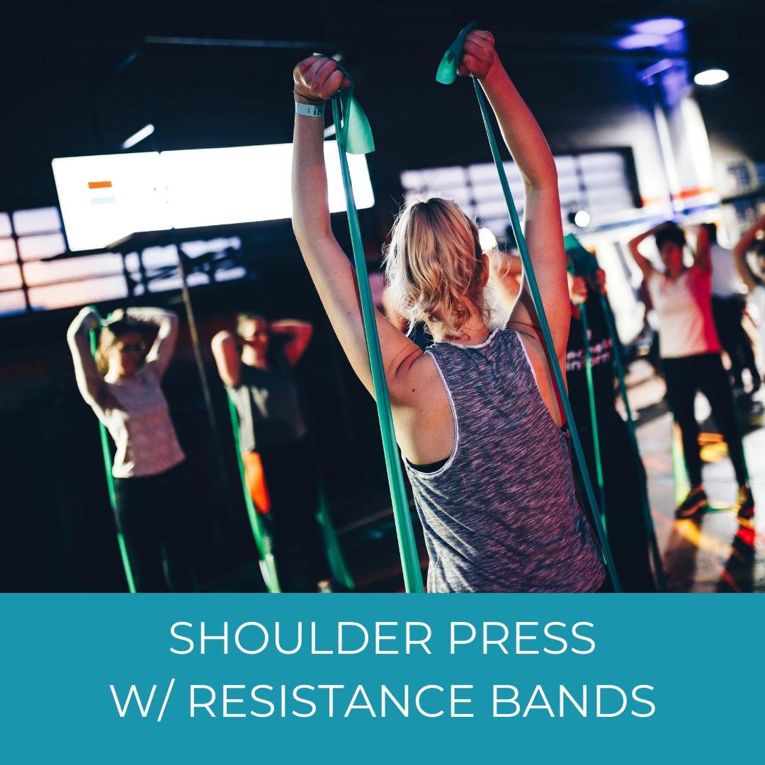 class of people doing shoulder presses with resistance bands